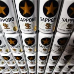 Cans of the Sapporo Black Label branded beer sit stacked at the Sapporo Breweries Ltd. factory in Eniwa, Hokkaido, Japan.