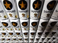 Cans of the Sapporo Black Label branded beer sit stacked at the Sapporo Breweries Ltd. factory in Eniwa, Hokkaido, Japan.