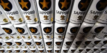 Cans of the Sapporo Black Label branded beer sit stacked at the Sapporo Breweries Ltd. factory in Eniwa, Hokkaido, Japan.