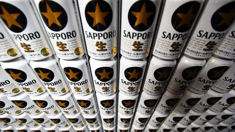 Cans of the Sapporo Black Label branded beer sit stacked at the Sapporo Breweries Ltd. factory in Eniwa, Hokkaido, Japan.